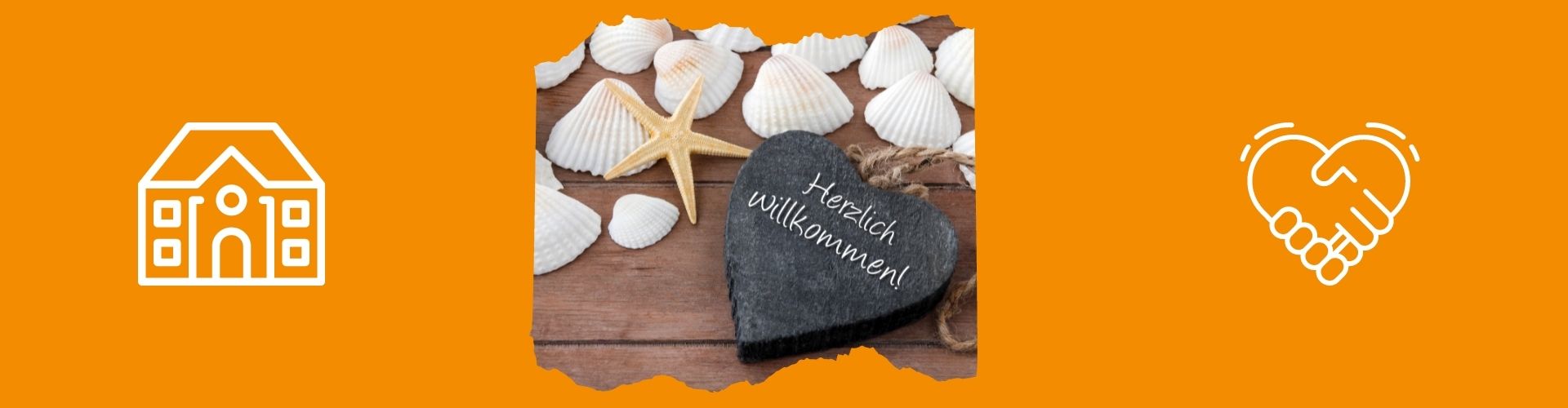 Muscheln und ein Herz mit Herzlich willkommen-Aufschrift