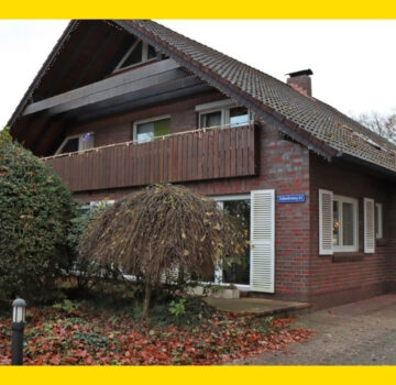 Das Wohngebäude "Die Schwalben" ist rot, hat ein Stockwerk mit Balkon, einen Dachboden und es einen Garten. Das Haus ist klein.