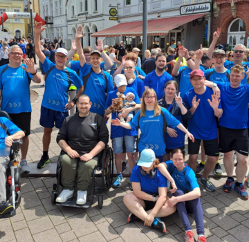 Ein Gruppenfoto mit vielen Leuten von der GPS. Viele haben blau-schwarze Sportsachen an.